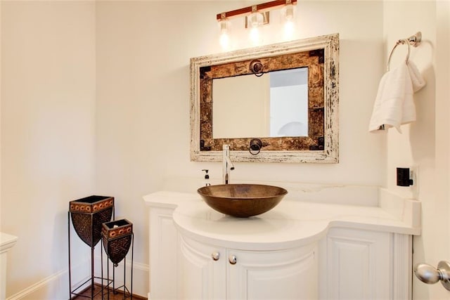 bathroom with baseboards and vanity