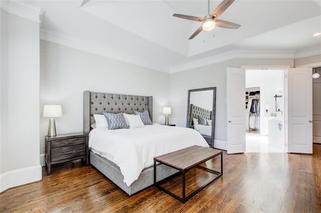 bedroom with ornamental molding, wood finished floors, a ceiling fan, and baseboards