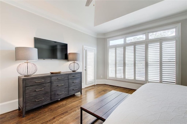 bedroom with ornamental molding, dark wood-style flooring, and baseboards