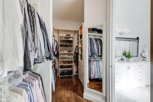 walk in closet with dark wood-type flooring