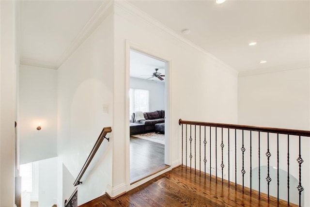 corridor featuring recessed lighting, an upstairs landing, baseboards, ornamental molding, and dark wood-style floors