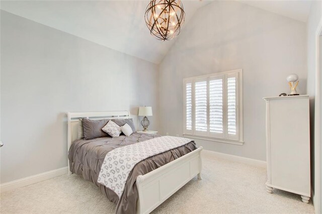 bedroom featuring lofted ceiling, light colored carpet, and baseboards