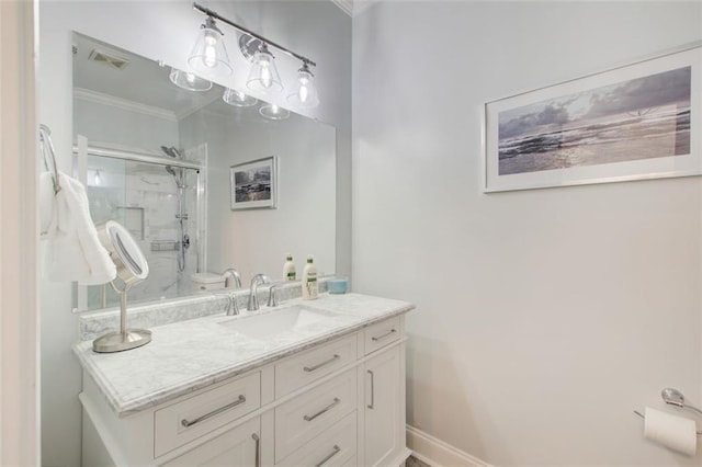 bathroom with crown molding, visible vents, vanity, a shower stall, and baseboards