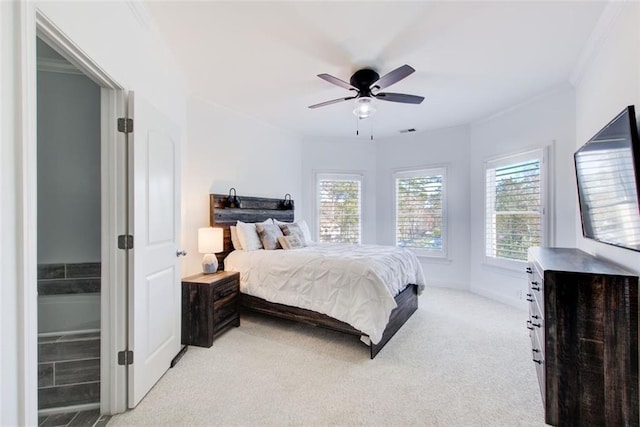 bedroom featuring visible vents, baseboards, light colored carpet, ceiling fan, and ornamental molding