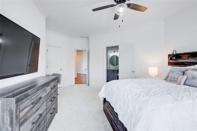 bedroom featuring a ceiling fan, ensuite bathroom, crown molding, and light colored carpet