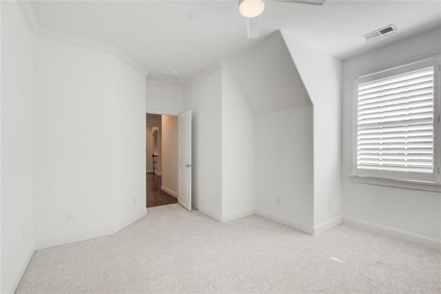 additional living space with baseboards, a ceiling fan, visible vents, and light colored carpet