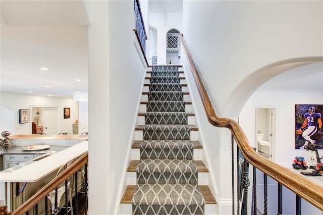 staircase featuring recessed lighting