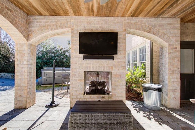 view of patio / terrace with an outdoor brick fireplace