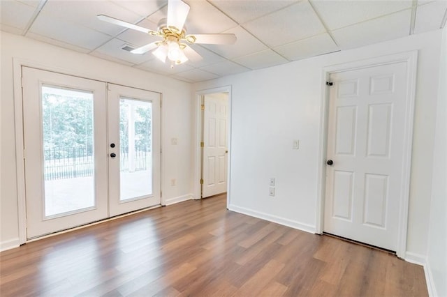 3664 Maple Forge Ln, Gainesville, GA 30504 - empty room with a drop ceiling, french doors, wood finished floors, and a ceiling fan