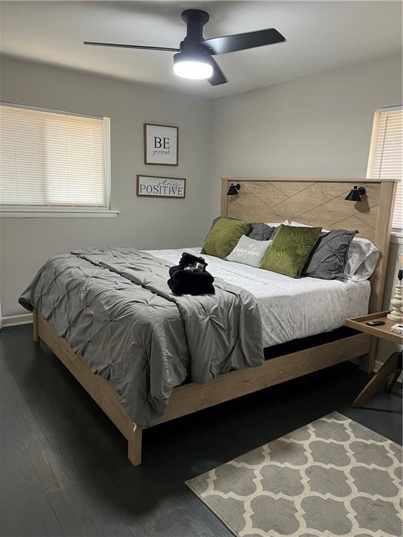 bedroom with multiple windows, a ceiling fan, and hardwood / wood-style flooring