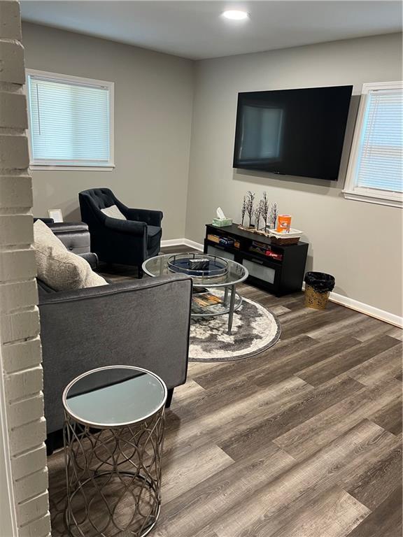 living room featuring baseboards and wood finished floors