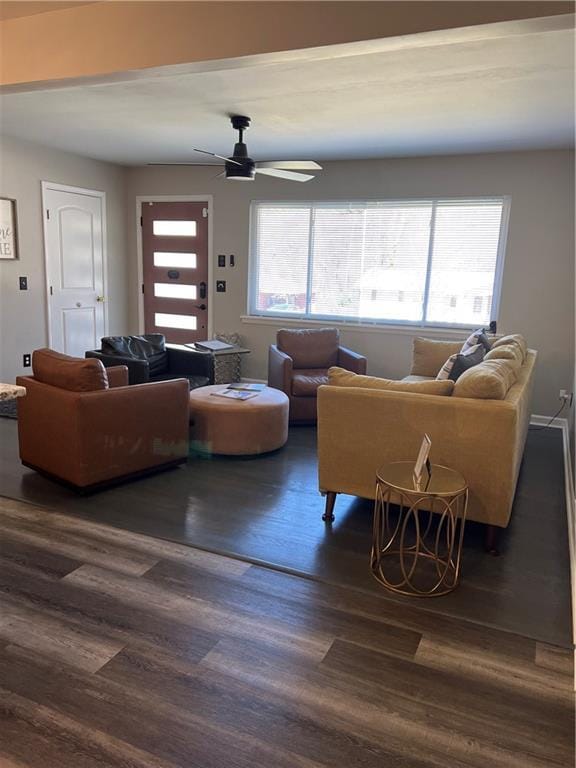 living area with dark wood finished floors and ceiling fan