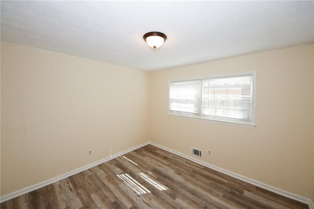 unfurnished room with hardwood / wood-style flooring