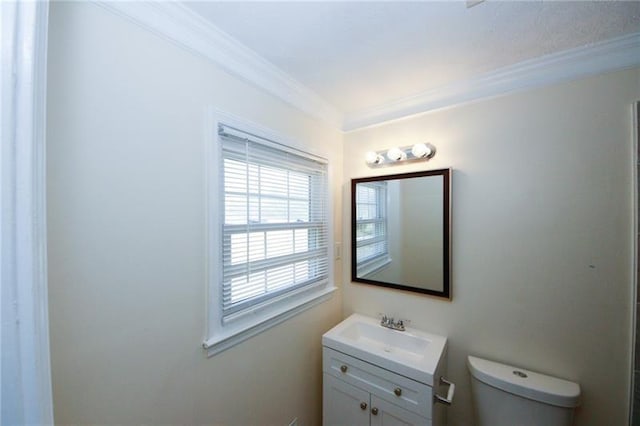 bathroom with vanity, ornamental molding, and toilet