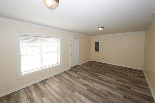 spare room with crown molding, wood-type flooring, and electric panel