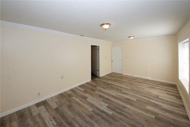 empty room with ornamental molding and dark wood-type flooring