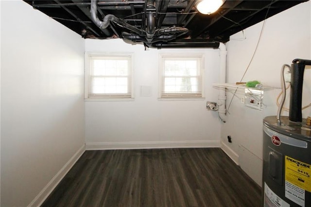 basement with electric water heater and dark hardwood / wood-style floors