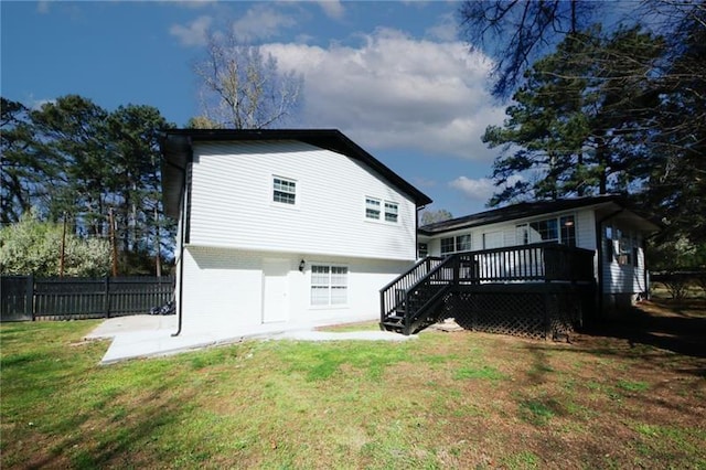 back of house with a yard and a deck