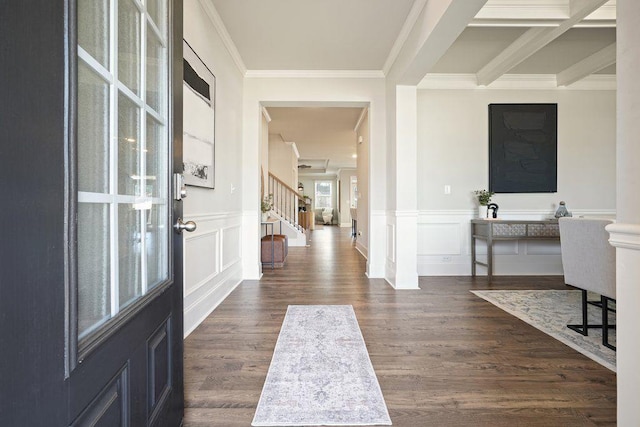 entryway featuring beam ceiling, ornamental molding, and dark hardwood / wood-style floors