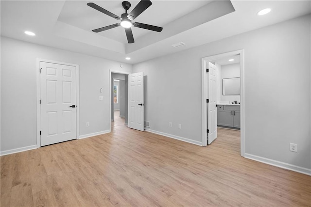 3156 Ozmer Lndg, Decatur, GA 30034 - unfurnished bedroom with a tray ceiling, light wood-style flooring, baseboards, recessed lighting, and ensuite bathroom