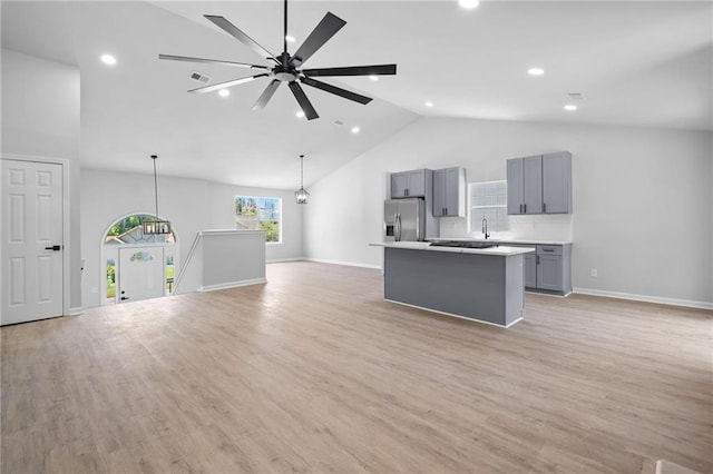 3156 Ozmer Lndg, Decatur, GA 30034 - kitchen featuring stainless steel fridge, gray cabinetry, a kitchen island, open floor plan, and high vaulted ceiling