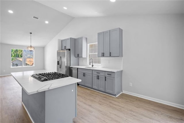 3156 Ozmer Lndg, Decatur, GA 30034 - kitchen featuring stainless steel appliances, gray cabinetry, a sink, lofted ceiling, and light wood-type flooring