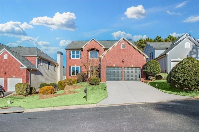 view of property featuring a front lawn and a garage