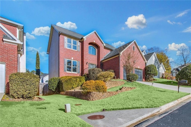 view of front property featuring a front lawn and a garage