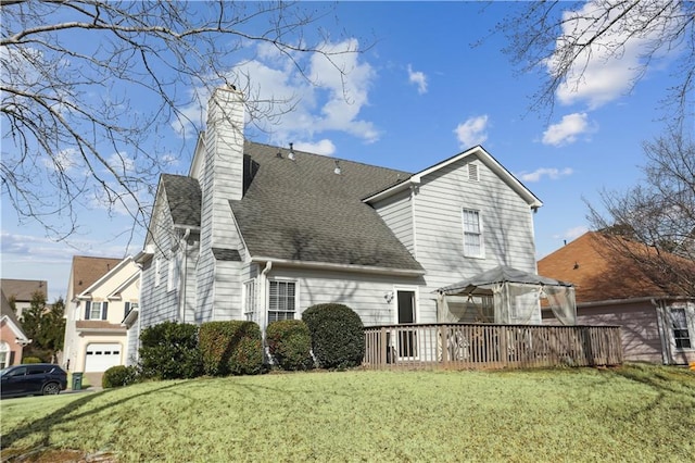 back of property featuring a chimney, a lawn, and a gazebo