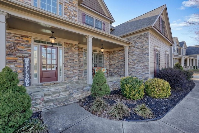 view of exterior entry with a porch