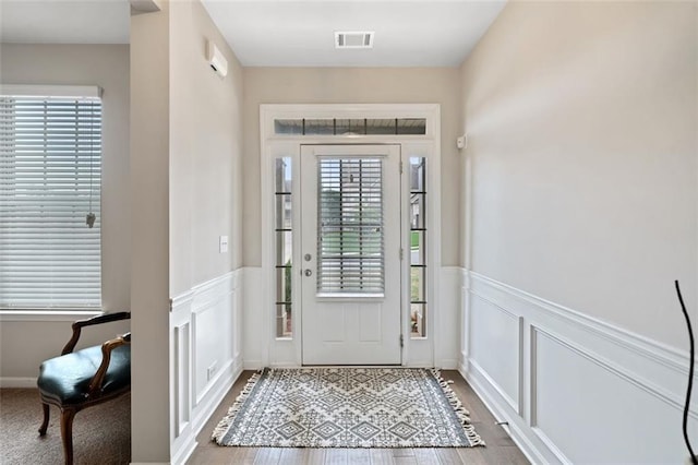 foyer entrance with hardwood / wood-style floors and a wealth of natural light