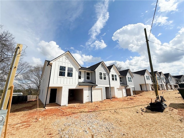 11596 E Lovejoy Rd, Hampton, GA 30228 - view of front of house with a residential view, a garage, board and batten siding, and fence