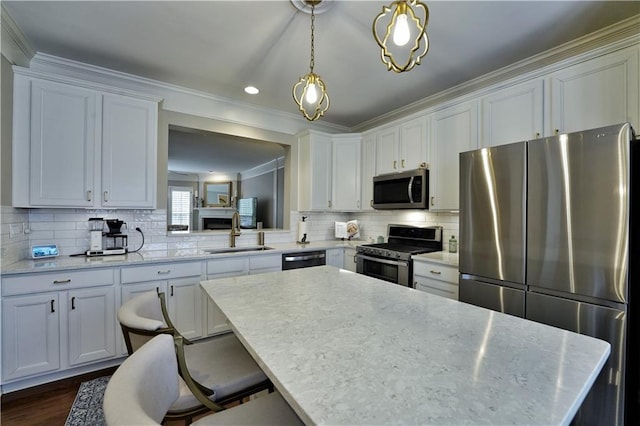 kitchen with white cabinets, light stone countertops, and stainless steel appliances