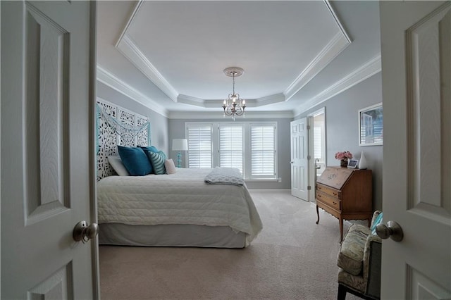 carpeted bedroom featuring a notable chandelier, a raised ceiling, and ornamental molding