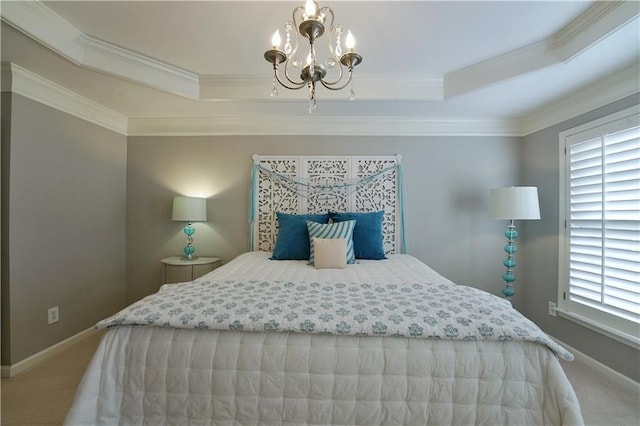 carpeted bedroom with a tray ceiling, crown molding, and a notable chandelier