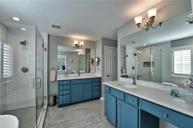 bathroom with vanity, an enclosed shower, and an inviting chandelier