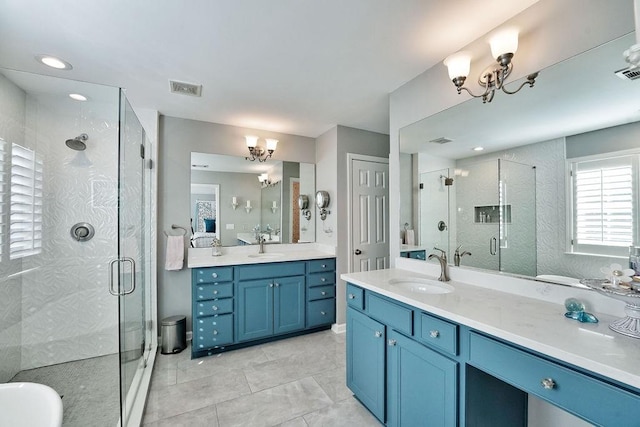 full bathroom featuring an inviting chandelier, two vanities, and a sink