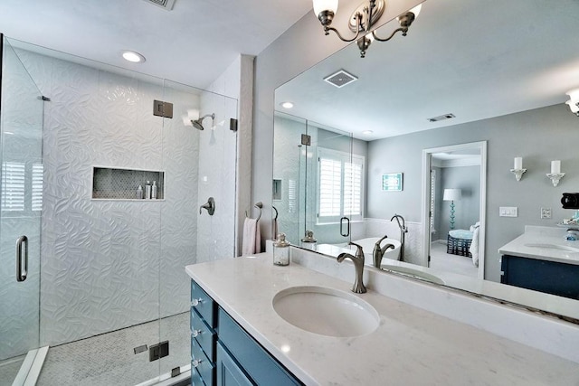 full bath with visible vents, vanity, a shower stall, and ensuite bathroom