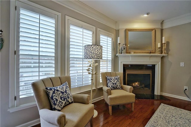 living area with a healthy amount of sunlight, ornamental molding, and dark wood-type flooring