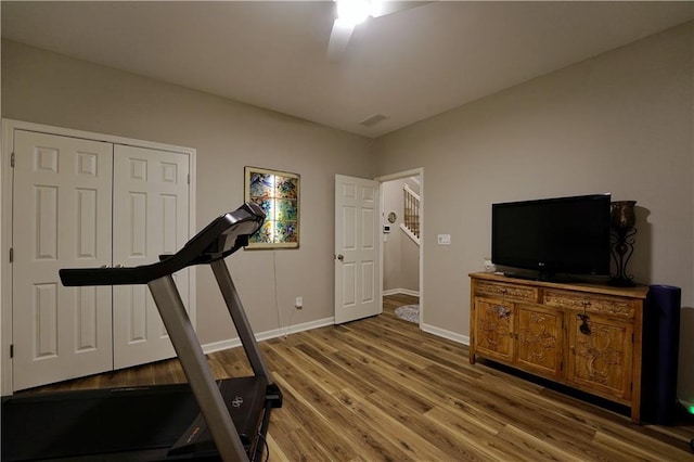 exercise room with wood-type flooring