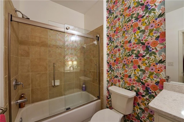 full bathroom with vanity, toilet, and shower / bath combination with glass door