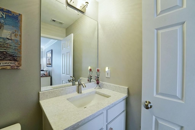 half bathroom featuring visible vents and vanity