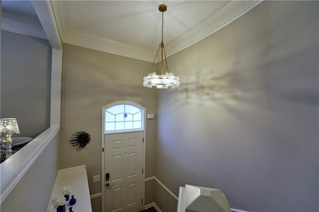 foyer featuring crown molding and a notable chandelier