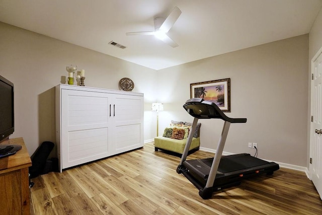 workout area featuring ceiling fan, light wood finished floors, visible vents, and baseboards