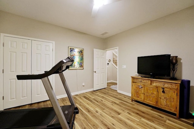 exercise area with light wood-type flooring, visible vents, and baseboards