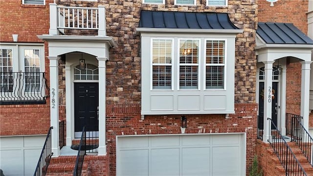 entrance to property with a standing seam roof, metal roof, and brick siding