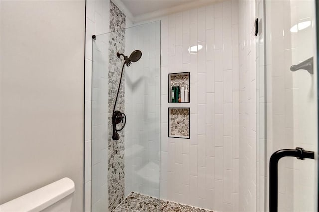 full bathroom featuring a stall shower and toilet
