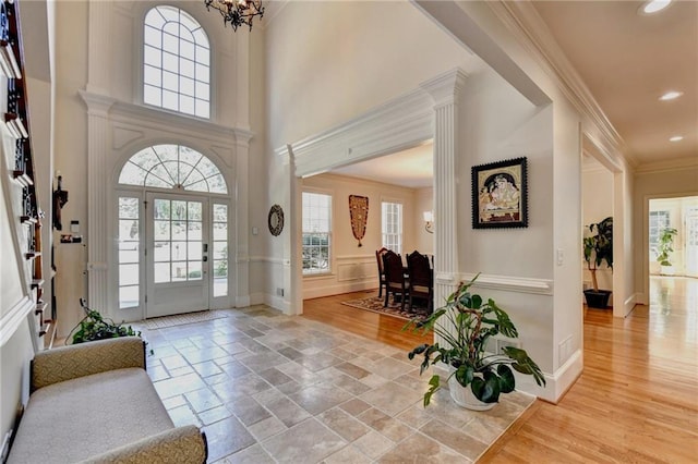 foyer with crown molding, an inviting chandelier, recessed lighting, baseboards, and wood finished floors