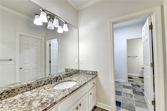 bathroom featuring baseboards, ornamental molding, stone finish floor, and vanity