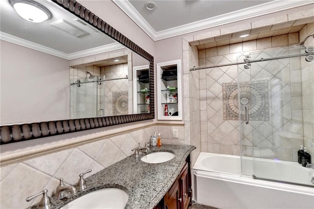full bath with a sink, tile walls, crown molding, and shower / bath combination with glass door